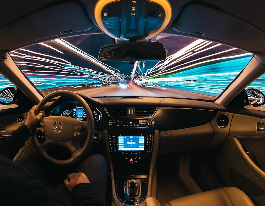 Driver behind the wheel at night with city lights streaking by, ready for a smarter coverage choice